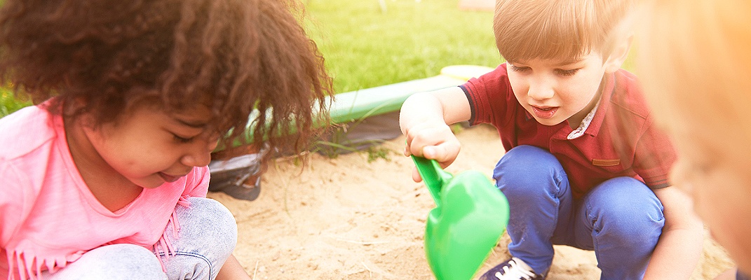 Children playing in a sandbox.